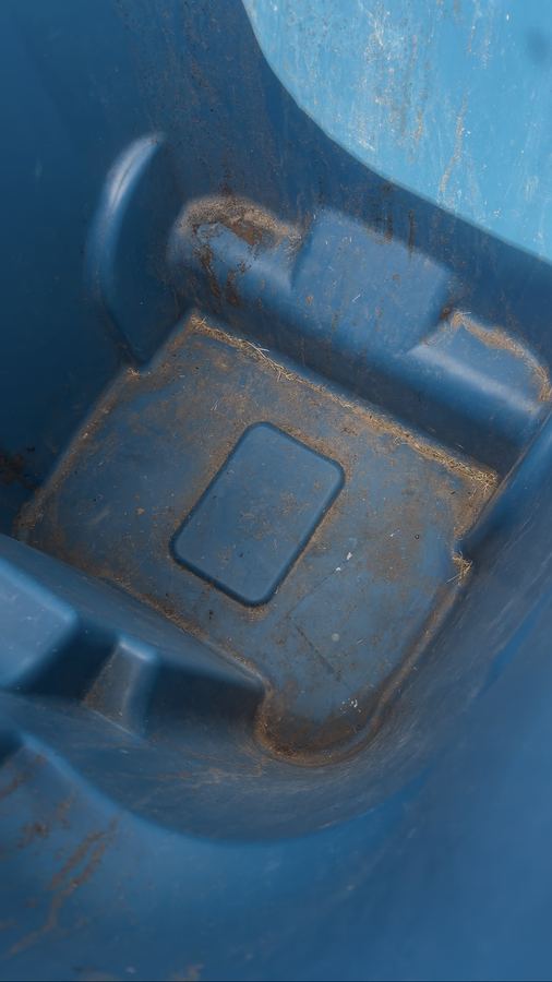 Bin with dirt and grass before
